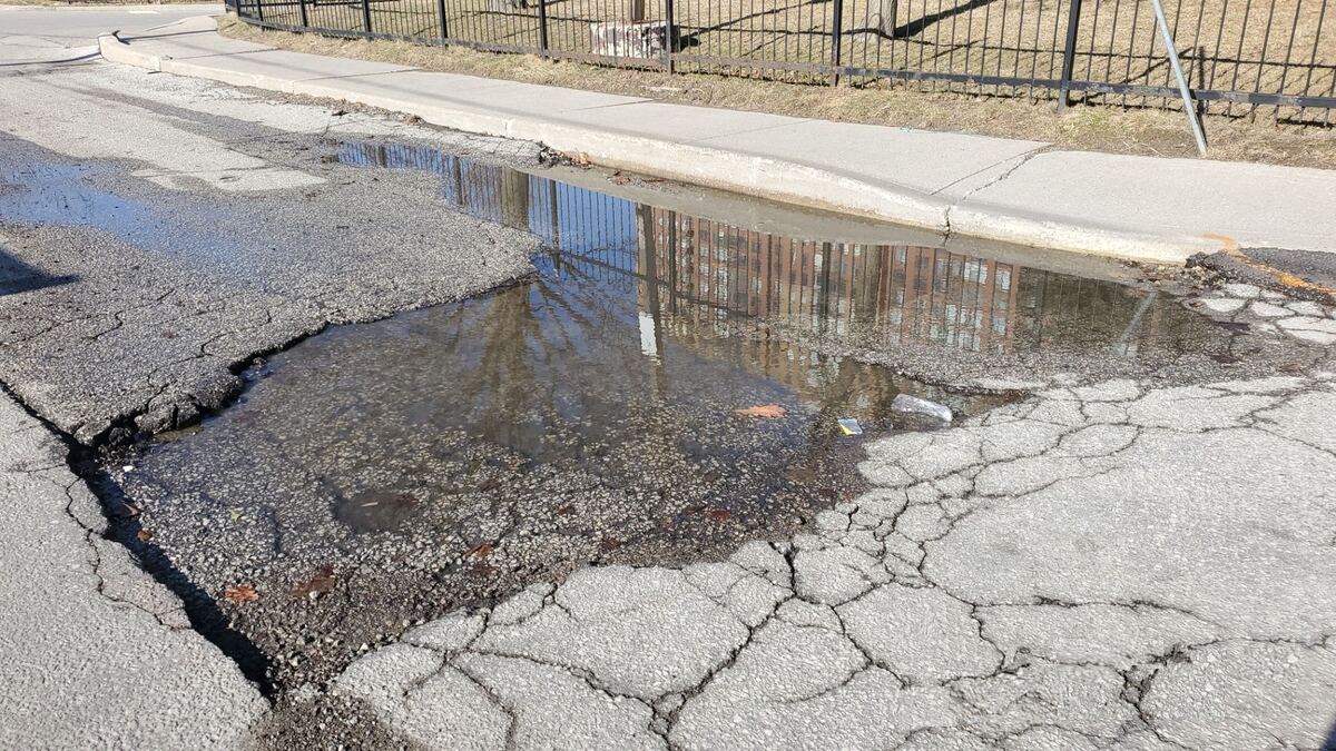 Deteriorated parking lot with potholes before sealcoating Beaufort SC